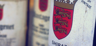 Close-up of a wine bottle label with a crest and text